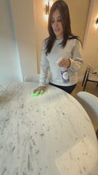 woman cleaning a marble table with natural cleaner